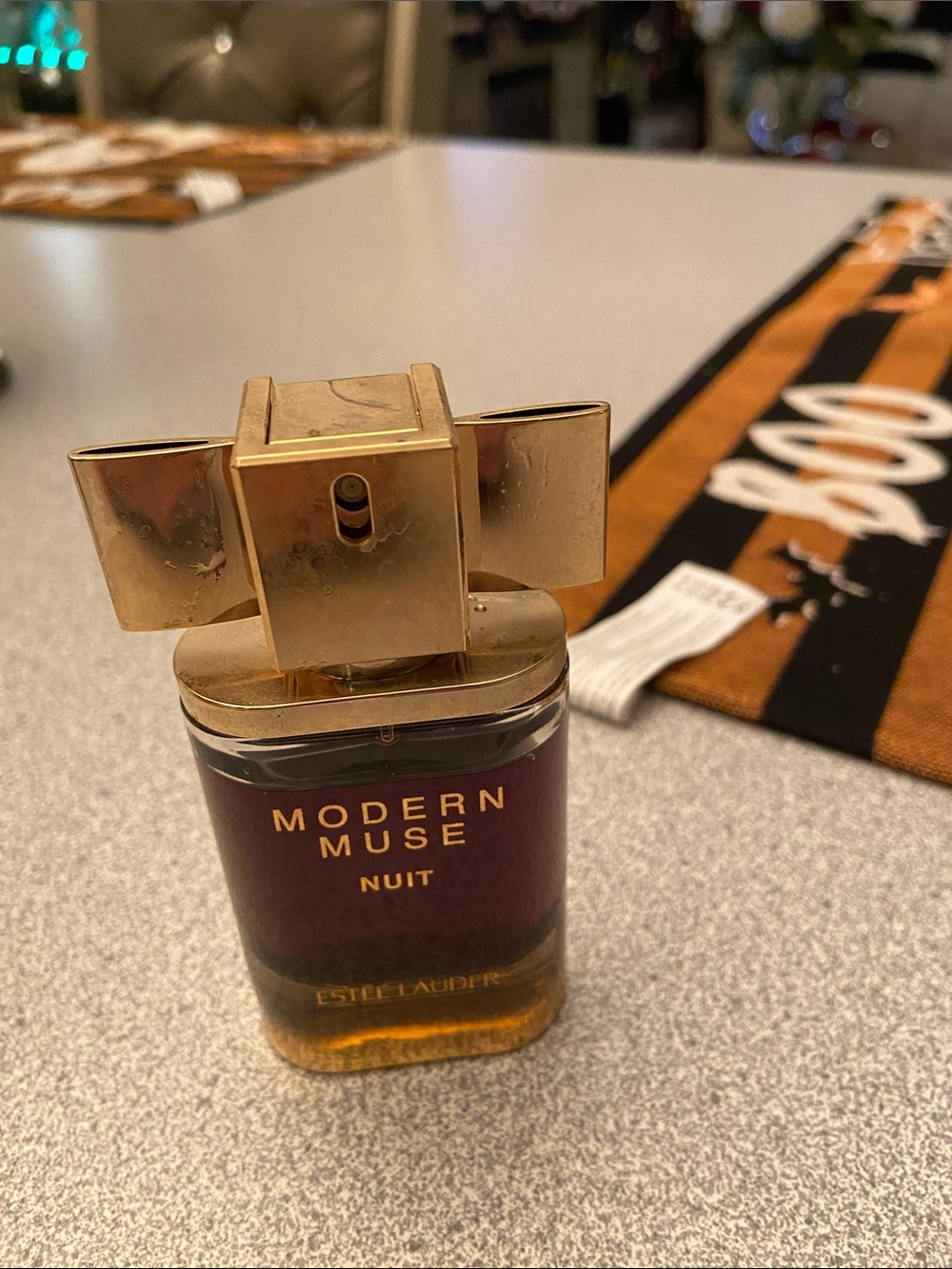Estee Lauder Modern Muse Nuit Bottle in Gold and Deep Purple